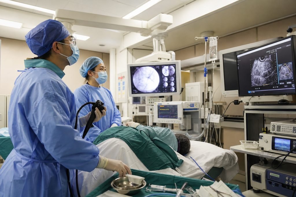 Illustrative image: Medical staff performing a procedure in an operating room with ultrasound imaging equipment.
