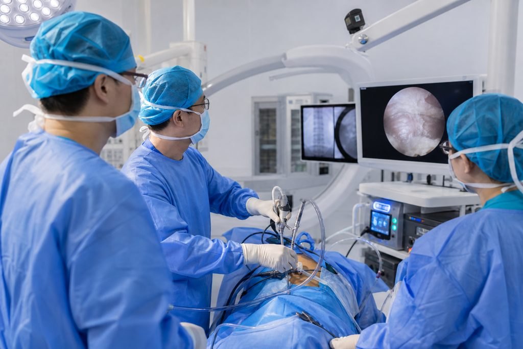 Illustrative image: A surgical team performs a procedure using an endoscope in an operating room.