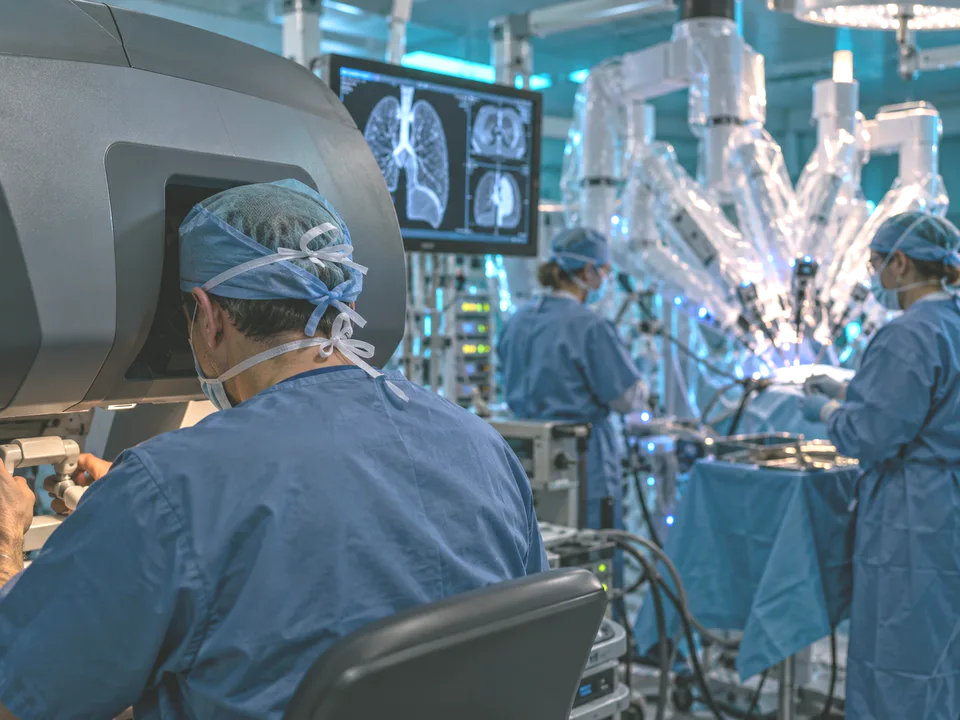 Thoracic surgeons performing minimally invasive chest surgery in an operating room